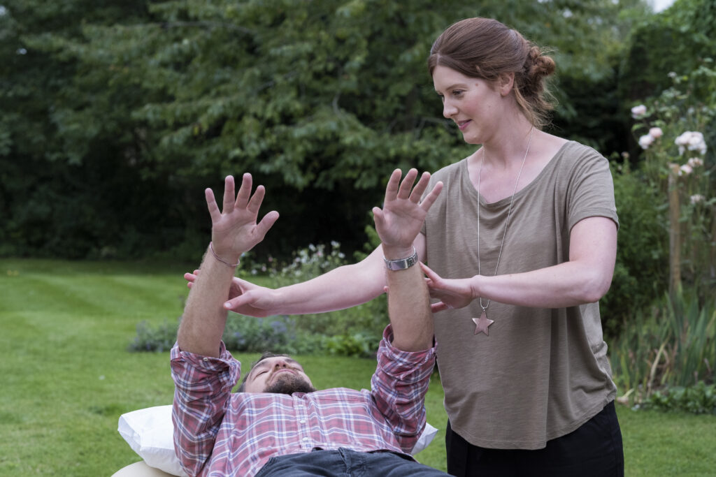 man on a couch and therapist raising his arms in a 2023 11 27 04 52 19 utc After Action an AM Health Care Program